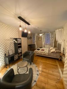 a bedroom with a bed and a chair and a table at Chambre D'hôte Villa Maurice in Étretat