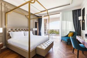 a bedroom with a canopy bed and a desk at Palazzo di Varignana in Varignana