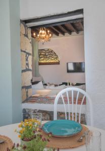 a room with a table with a plate on a chair at Philoxenia traditional house in Pastida