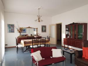 a living room with a table and a dining room at Appartamento Raggio Di Sole in Acireale