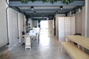 an office with desks and a laptop on a table at The Cube Hostel Khaosan in Bangkok