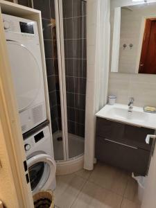 a bathroom with a washing machine and a sink at Ski Arcs 1800 Ruitor in Arc 1800