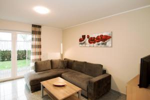 a living room with a couch and a table at Ferienwohnung Jacobs EG in Norddeich