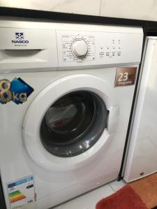 a white washing machine in a room at Studio Confort Fann Hock in Dakar