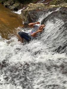 a man is on a raft in a waterfall at simply heaven suriyakanda in Suriyakanda