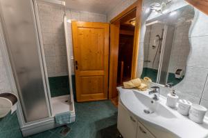 a bathroom with a sink and a shower at Korošec Apartments and Wellness Centre in Mozirje