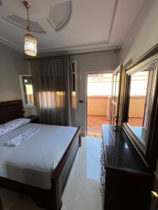 a bedroom with a bed and a view of a patio at Appartement boulaàyoun de luxe à louer nador 3 in Nador