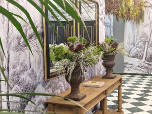 two vases on a table with plants on it at Hotel Boutique Las Almenas in Granada