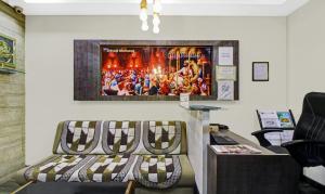 a waiting room with a bench and a poster on the wall at Treebo Trend Baby Pearl in Amrāvati