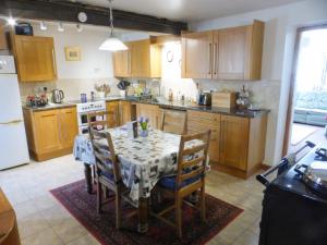 a kitchen with a table and chairs in a room at Sally End in Ravenstonedale
