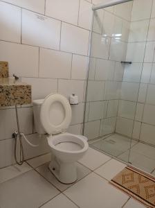 a bathroom with a toilet and a shower at Pouso Casa da Vovó in Tiradentes +83 photos