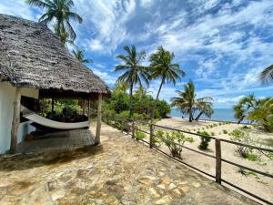 a resort with a hammock on the beach at Baobab Beach Villa, Ushongo Beach, Pangani in Ushongo Mabaoni +30 photos