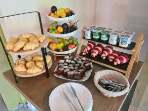 a table with plates of food and bowls of fruit at New Wolf in Bran +208 photos