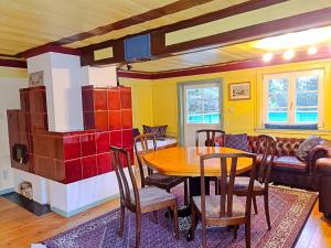 a dining room with a table and chairs and a couch at Haus Völlegg in Völlegg