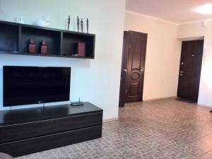 a living room with a flat screen tv on a wall at Apartments NEW in Mykolaiv