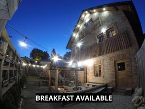 a building with lights on it with the words breakfast available at Liptov Lodge in Liptovský Mikuláš