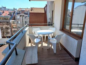 a patio with a table and chairs on a balcony at APARTMENT TONI / 2BEDROOMS in Varna City