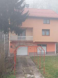 una casa con un cancello arancione davanti di Robi kula a Visoko