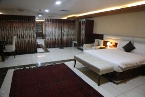 的住宿－The Burj Ghazanfar in Mazar-e Sharif，一间卧室配有一张大床和一张沙发