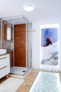 a bathroom with a glass shower with a person in the window at Podlesice 38 in Kroczyce