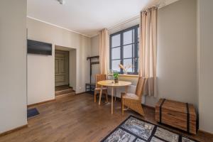 a living room with a table and chairs and a window at Enjoy Old Town vibes in 1716 Laipu Residence with 4 stylish Apartments and 1 Penthouse in Rīga