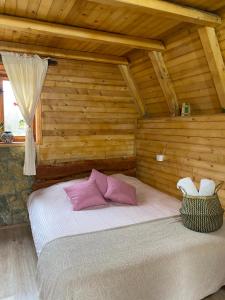 um quarto com uma cama em um quarto de madeira em Eco kutak em Mojkovac