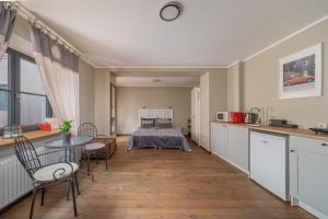 a kitchen and living room with a table and chairs at Enjoy Old Town vibes in 1716 Laipu Residence with 4 stylish Apartments and 1 Penthouse in Riga