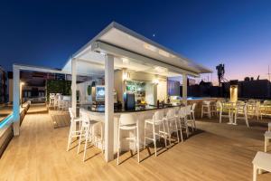 a bar on the roof of a building at night at Odyssey Rooms Alicante in Alicante