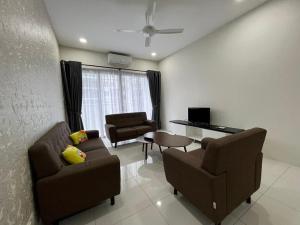 a living room with a couch and chairs and a table at Homestay P residence 3 bedroom and 2 bathroom in Kuching