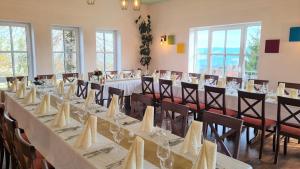 a conference room with a long table and chairs at Pension Breitenborn in Masserberg