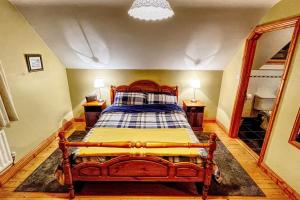 a bedroom with a wooden bed in a room at Gemütliches Cottage mit atemberaubender Aussicht in An Geata Mór
