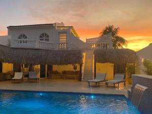 a villa with a swimming pool at sunset at Beach Walk Residences in Palm-Eagle Beach