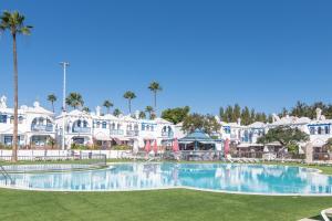 a large swimming pool in front of a resort at Duplex Poolside Playa del Ingles in Playa del Ingles