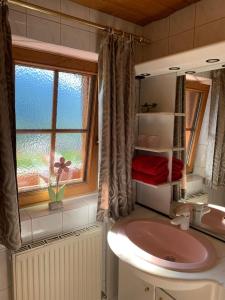 a bathroom with a sink and a window at Jägerhof in Alpbach +98 photos