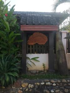 a small house with a sign on the side of it at Lattanavongsa guesthouse and Bungalows in Muang Ngoy