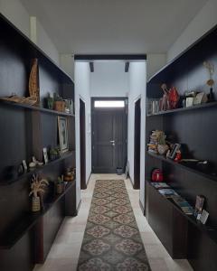 a hallway with a door and a rug in a room at sa ribera in Càbras