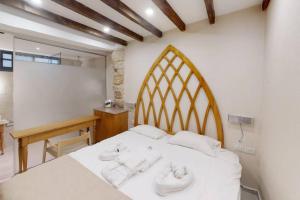 a bedroom with a bed with white sheets and a desk at The house in the Ramchal in Acre +11 photos