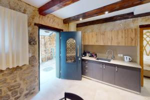 a kitchen with a blue door in a room at The house in the Ramchal in Acre