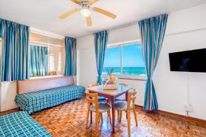 a living room with a table and a couch at Impala Holiday Flats & Apartments in Durban