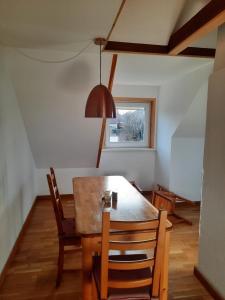 a dining room with a table and chairs and a window at cosy home in Dresden