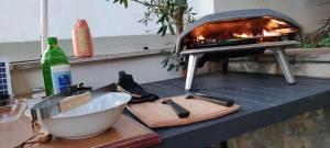 a kitchen counter with a pizza oven and a sink at La Casa di Elisa in Hvar