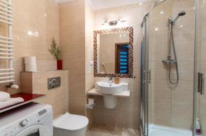 a bathroom with a shower and a toilet and a sink at Golden Apartments Warsaw - Big and Bright Apartment in Platinum Towers- Browary- Grzyb61A in Warsaw