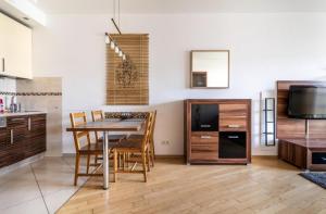 a kitchen and dining room with a table and chairs at Golden Apartments Warsaw - Big and Bright Apartment in Platinum Towers- Browary- Grzyb61A in Warsaw
