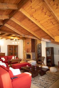 a living room with red couches and a fireplace at Soffitta House Sofi! in Florina