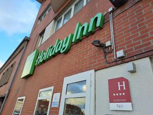 a building with a sign on the side of it at Holiday Inn Calais-Centre, an IHG Hotel in Calais