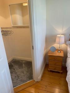 a bedroom with a bed and a table with a lamp at Home On The Edge Of Ireland! in Belmullet