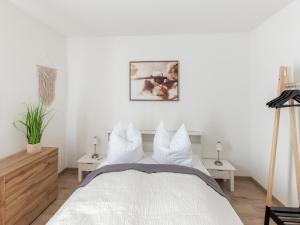 a bedroom with a white bed with white pillows at Cozy holiday home in Bavaria in a charming area in Beilngries