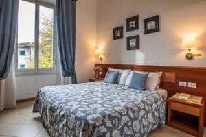 Postel nebo postele na pokoji v ubytování Hotel Bonifacio