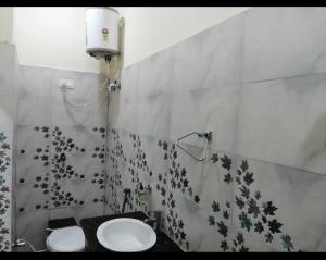 a bathroom with a sink and a toilet at Anant Royal in Govardhan