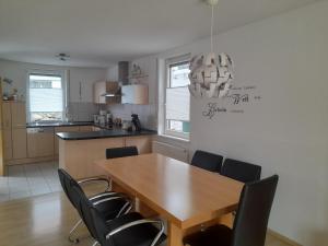 a kitchen with a dining room table and chairs at Sonnenparkhaus in Roth